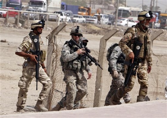 U.S. Army soldiers and Iraqi security forces secure the scene of a roadside bomb attack in Basra, Iraq's second-largest city, on Wednesday.